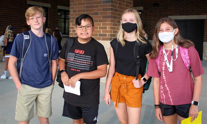 A groups of students smiles